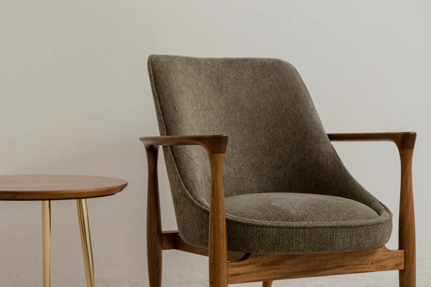 Fabric armchair and side table in a furnished hire home