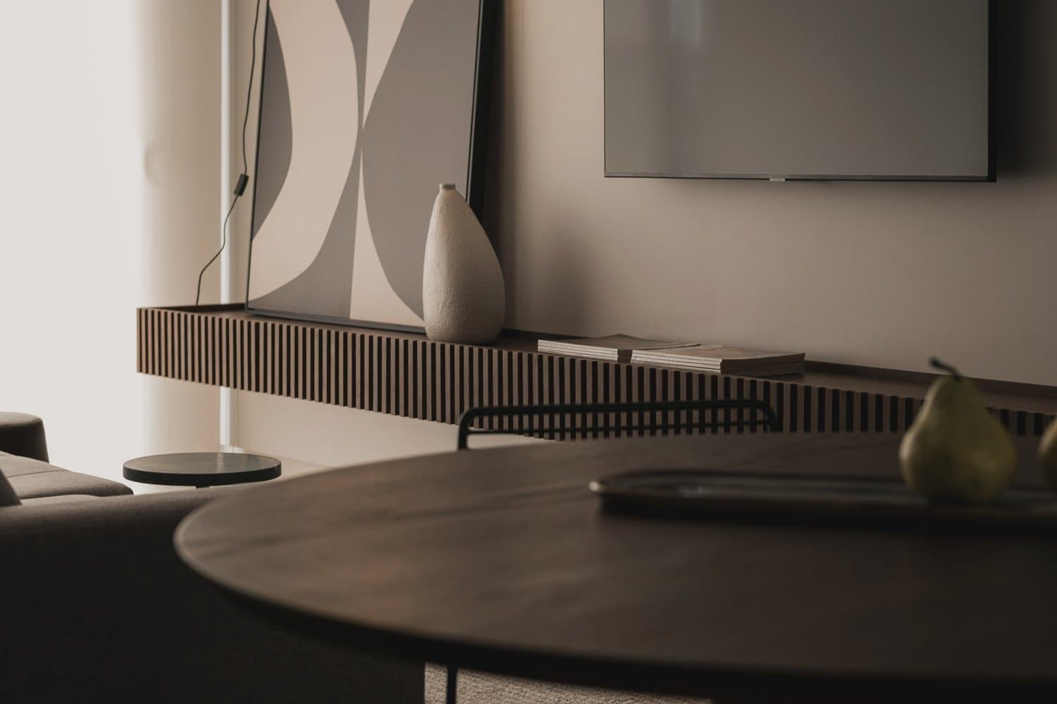 Wall-mounted TV and entertainment unit in a hire home