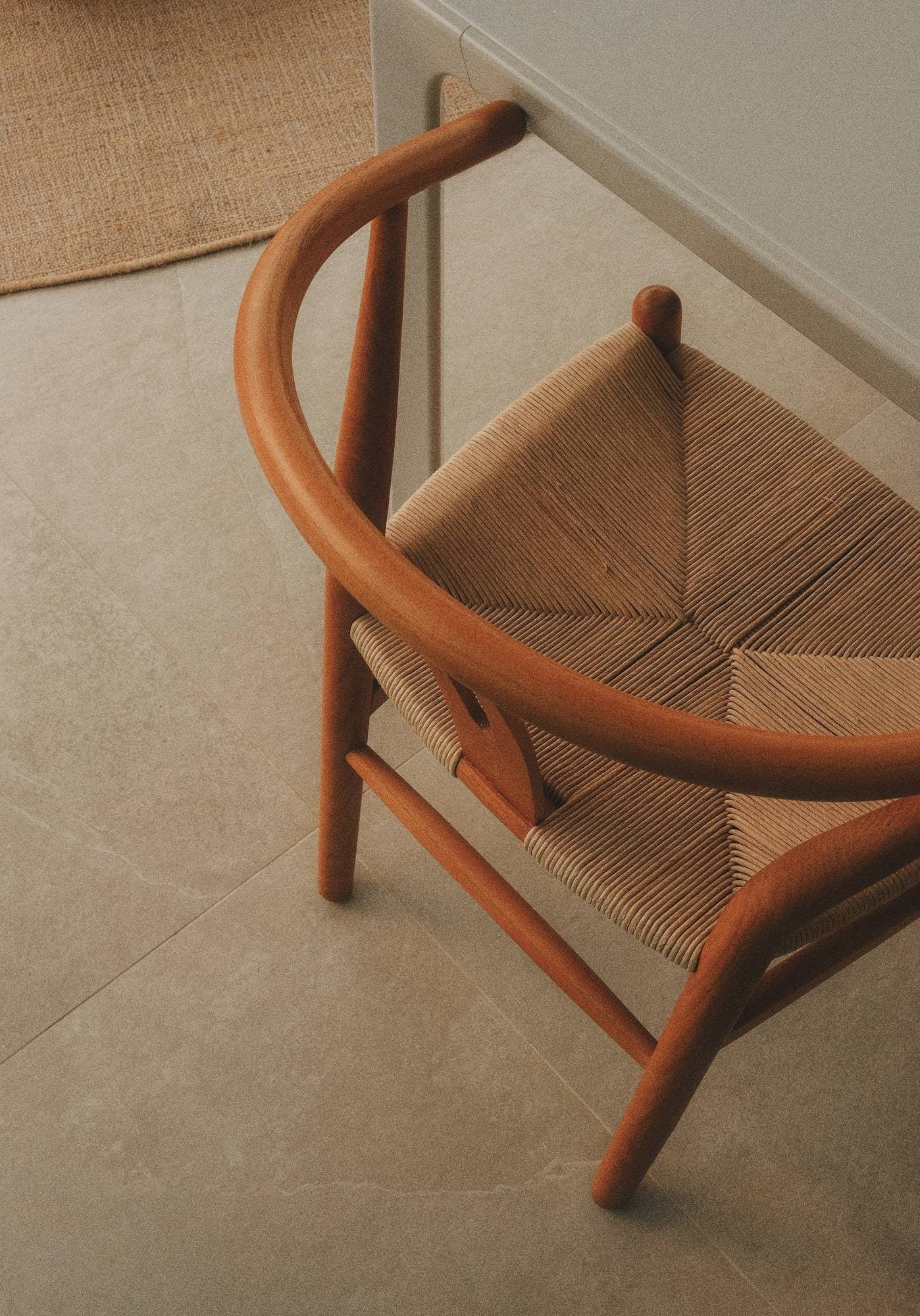 Timber armchair and side table in a furnished Lake Macquarie home